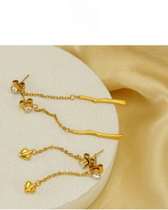 Close-up of 18K gold plated tassel and heart earrings with lead-free and nickel-free finish