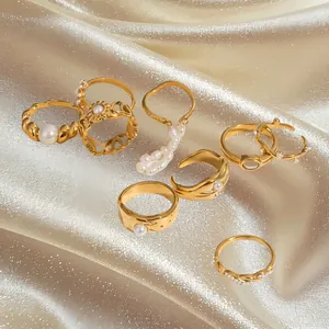 Elegant 7-piece gold-plated stainless steel ring set with white pearls on luxury satin