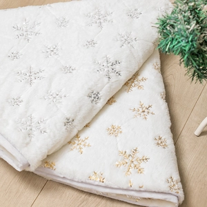 White plush Christmas tree skirt with gold and silver sequin snowflake patterns