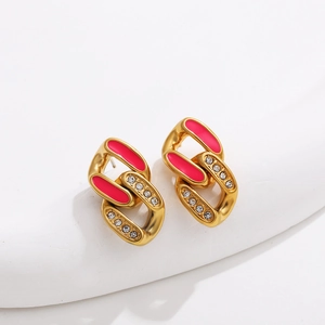 Close-up of gold-plated chain link earrings with pink enamel and sparkling zircons