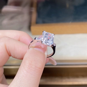 Macro shot of S925 silver radiant cut high carbon diamond ring with trapezoid side stones