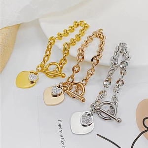 Detailed macro view of the double heart pendants and OT buckle on the chain bracelet