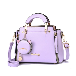 Lilac purple leather tote bag with cat charm and gold hardware for women, 45-degree view