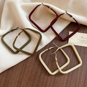 Detailed view of matte geometric square hoop earrings in burgundy, olive green and cream