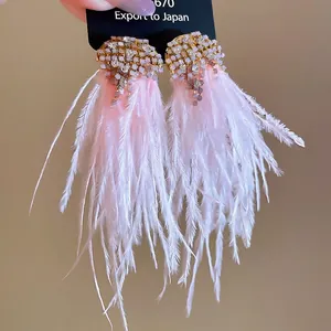 Elegant gold feather tassel earrings with sparkling pink rhinestones and soft pink plumage