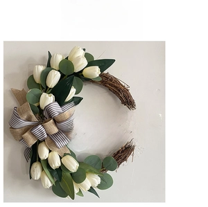 Detail of tulip wreath showing Welcome to our home wood sign and striped ribbon bow