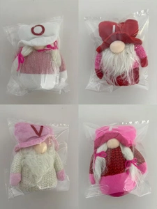 Detailed close-up of handmade Valentine's gnomes in protective packaging for retail