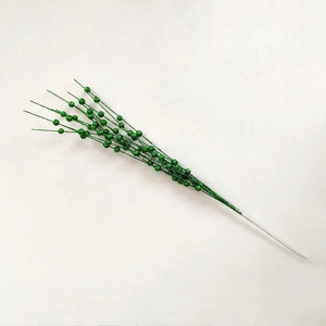 Macro detail of green artificial berry branch with glitter coating for Christmas decor
