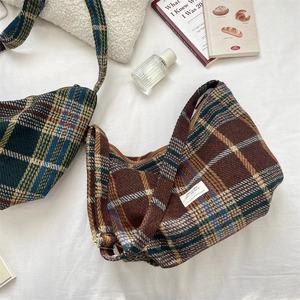 Detail view of large capacity vintage plaid hobo bags with wool woven texture and metal buckles