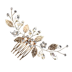 Detailed view of the gold leaf hair comb with sparkling rhinestones and white pearls
