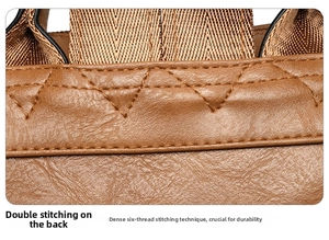 Detail of reinforced double stitching on brown lychee texture leather backpack