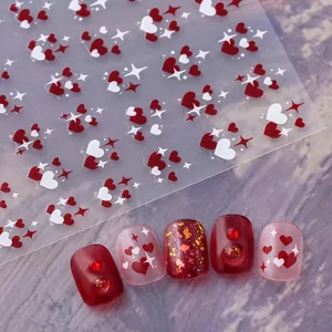 Macro detail of red and white heart nail stickers and finished manicure art design