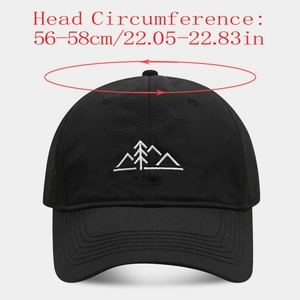 Détail de la broderie de montagnes blanches sur une casquette de baseball noire en coton