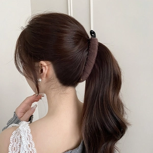Elegant brown knitted hair clip for women shown on model hair for a minimalist autumn look