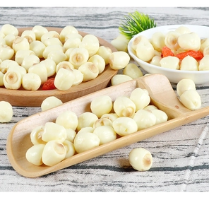 Realistic PVC lotus seed model props with white seeds and wolfberry on a wooden tray