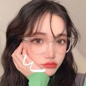 Close-up of a stylish woman wearing vintage round transparent frames with anti-blue light lenses