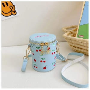 Detail of light blue cherry print bucket bag with golden flower zipper and strap