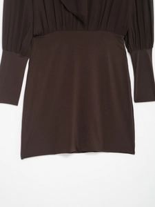 Detail of dark brown mini dress featuring chiffon pleated sleeves and knit patchwork texture