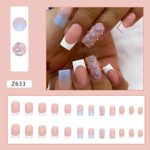 Blue French gradient press-on nails with floral patterns and small pearl accents
