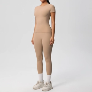 Close-up of nude high-waisted yoga leggings and short sleeve tee in matte stretchy fabric