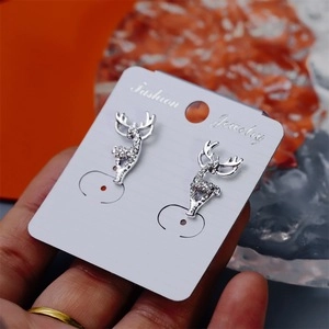 Close-up of silver elk stud earrings with crystal rhinestones for Christmas