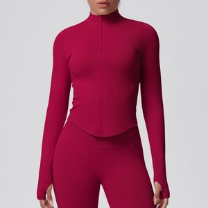 Close-up of cranberry red yoga jacket with stand collar, full zipper and thumbhole cuffs
