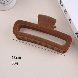 Detail shot of a 13cm brown flocked hair claw clip with size and weight measurements