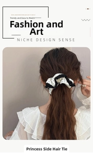 Detail of vintage polka dot lace scrunchie worn on a ponytail for elegant hair styling