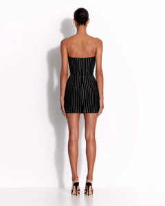 Detail of black bodycon mini dress featuring silver vertical pinstripes and slim fit back
