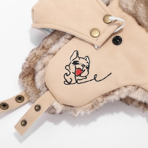 Detailed macro view of beige pet aviator hat with thick grey faux fur lining and dog embroidery
