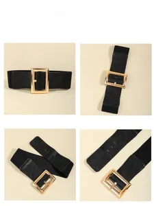 Macro detail of elastic black waist belt featuring a polished gold rectangular buckle