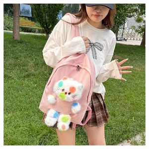 Zaino gatto in peluche rosa da donna con dettagli bianchi mostrato in un parco