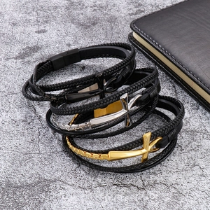 Three-piece set of woven leather cross bracelets in black, silver, and gold finishes