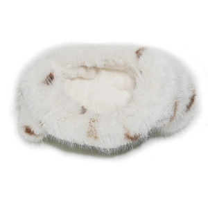 Detail showing plush white faux fox fur with leopard spots on a warm winter trapper hat