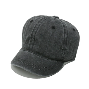 Detail of dark grey washed cotton baseball cap with short brim and vintage texture