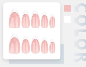 Detailed flat lay of pink French tip press-on nails with white almond tips on display