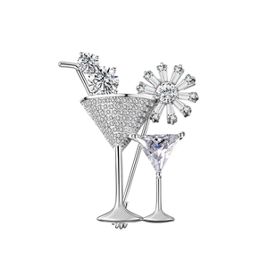 Macro shot of silver cocktail glass brooch featuring pave-set zircon stones and crystals
