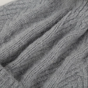 Close-up of grey knitted winter hat showing premium soft fuzzy rabbit fur texture