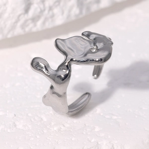 Close-up of irregular silver titanium steel ring with minimalist lava texture design
