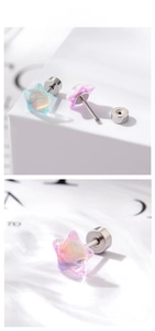 Detailed view of dreamy star screw-back studs in iridescent blue and pink tones