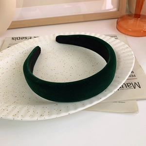 Close-up of vintage dark green velvet headband texture with plush sponge padding