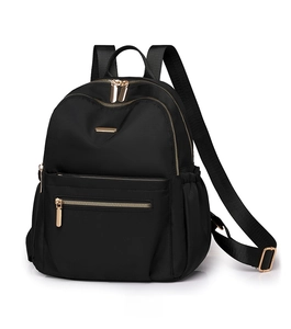 Detailed side view of black nylon backpack featuring golden zippers and waterproof texture