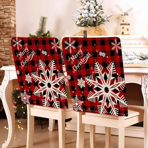 Close-up of red and black plaid Christmas chair covers with white snowflake and Merry Christmas