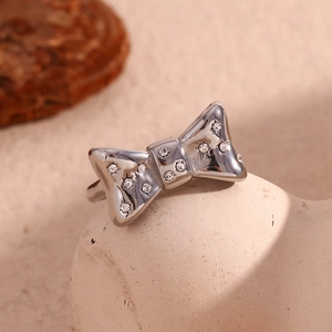 Macro shot of silver bow ring with micro-pave crystals on a ceramic stand