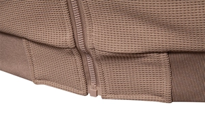 Close-up of brown waffle textured fabric featuring resin zipper and ribbed hem details