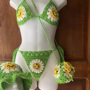 Detailed view of handmade green crochet bikini set with sunflower smile face accents
