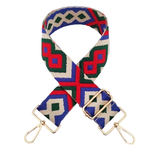 Close-up of 5cm geometric jacquard woven strap with golden metal hooks and buckle