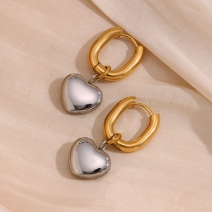 Elegant two-tone 18K gold plated heart drop earrings on champagne satin background