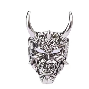 Detailed close-up of a vintage oxidized silver Hannya mask ring with intricate textures