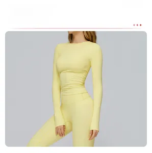 Detail of light yellow slim fit long sleeve sports top and high waist leggings yoga set